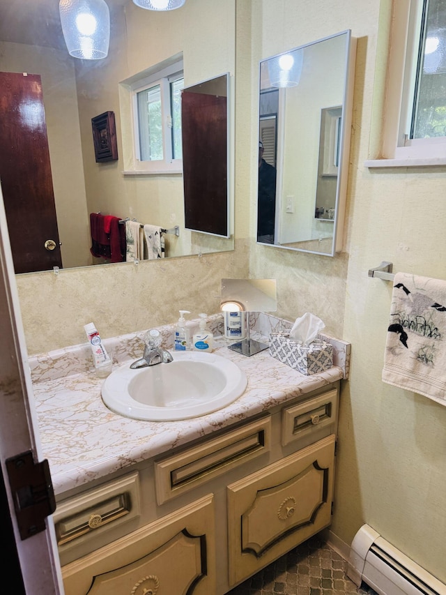 17745 Shubert Hwy, Alpena, MI 49707 - bathroom featuring a baseboard heating unit, vanity, and decorative backsplash
