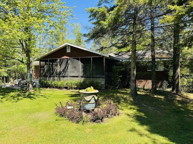 17745 Shubert Hwy, Alpena, MI 49707 - back of property featuring a sunroom and a lawn