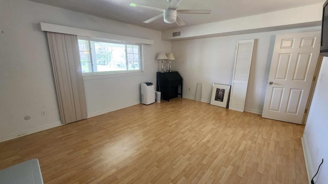 unfurnished bedroom featuring visible vents, a ceiling fan, light wood finished floors, and baseboards