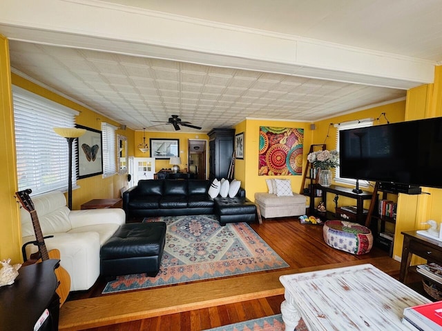 1106 Houghton View Dr, Houghton Lake, MI 48629 - living area with wood finished floors, a ceiling fan, ornamental molding, and a wainscoted wall