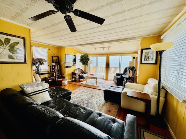 1106 Houghton View Dr, Houghton Lake, MI 48629 - living room featuring wood finished floors, healthy amount of natural light, ornamental molding, ceiling fan, and an ornate ceiling
