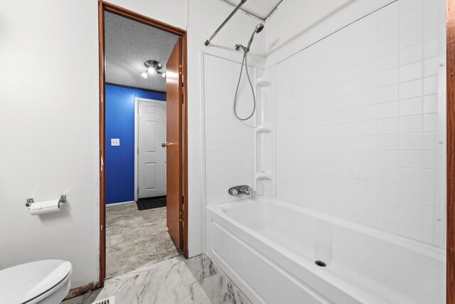 full bath featuring toilet, baseboards, shower / bath combination, and marble finish floor