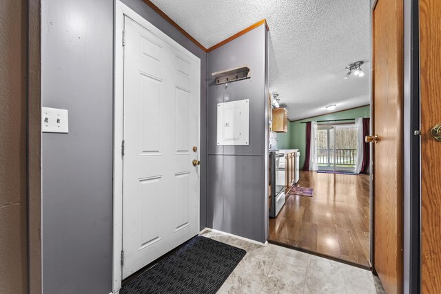 entryway with a textured ceiling and vaulted ceiling