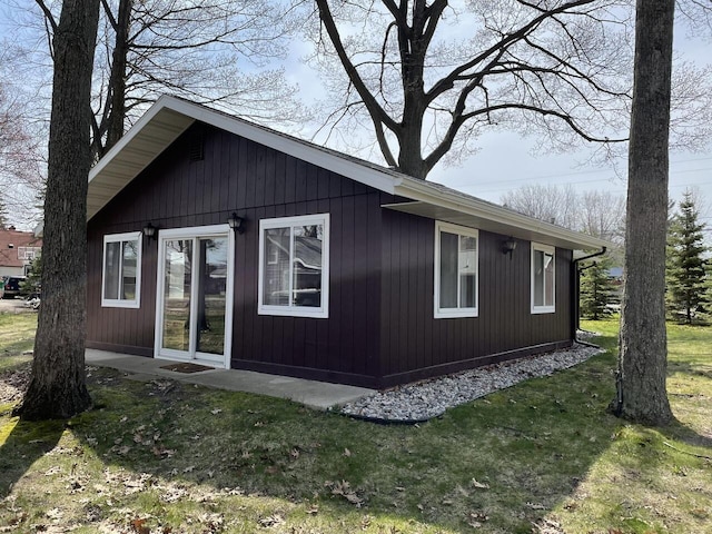 view of side of property with a yard