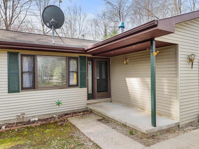 321 Greenleaf Dr, Houghton Lake, MI 48629 - property entrance with a shingled roof