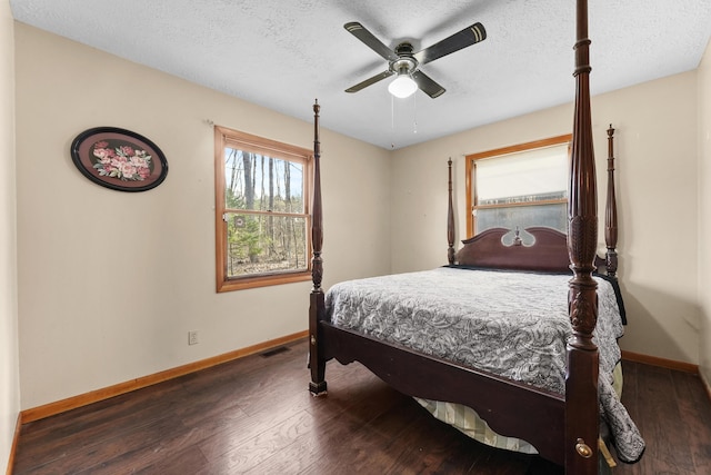 321 Greenleaf Dr, Houghton Lake, MI 48629 - bedroom with a textured ceiling, baseboards, ceiling fan, and wood finished floors