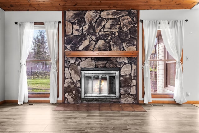 321 Greenleaf Dr, Houghton Lake, MI 48629 - room details featuring baseboards, wood ceiling, wood finished floors, and a fireplace