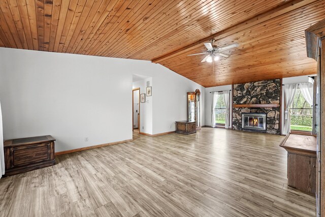 321 Greenleaf Dr, Houghton Lake, MI 48629 - unfurnished living room with baseboards, wood finished floors, vaulted ceiling, and a healthy amount of sunlight