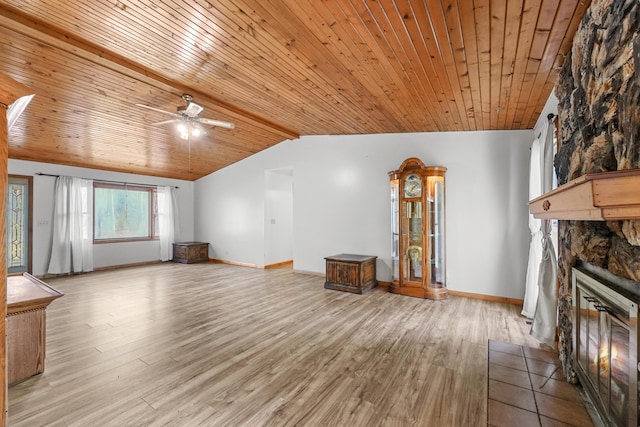 321 Greenleaf Dr, Houghton Lake, MI 48629 - unfurnished living room with a stone fireplace, ceiling fan, wooden ceiling, light wood finished floors, and vaulted ceiling
