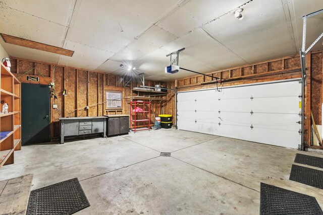 321 Greenleaf Dr, Houghton Lake, MI 48629 - garage featuring a garage door opener