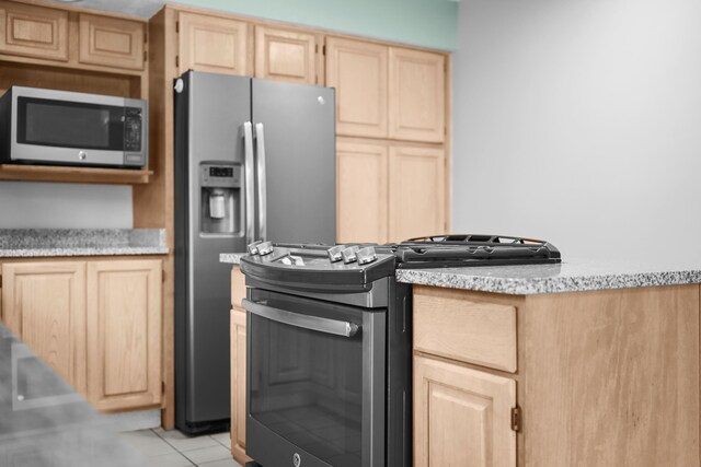 321 Greenleaf Dr, Houghton Lake, MI 48629 - kitchen featuring light brown cabinetry, appliances with stainless steel finishes, light tile patterned floors, and light countertops