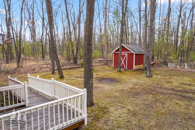 2931 Boulan Dr, Lewiston, MI 49756 - view of yard featuring a storage unit, an outbuilding, and a deck