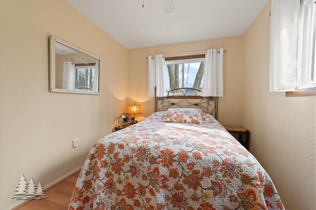 2931 Boulan Dr, Lewiston, MI 49756 - bedroom featuring baseboards, ceiling fan, and wood finished floors