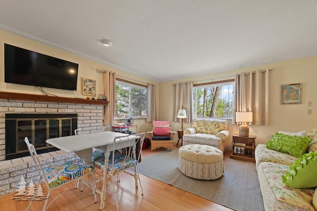 2931 Boulan Dr, Lewiston, MI 49756 - living room with crown molding, wood finished floors, and a fireplace