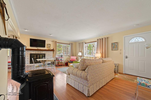 2931 Boulan Dr, Lewiston, MI 49756 - living area with ornamental molding, a fireplace, and wood finished floors