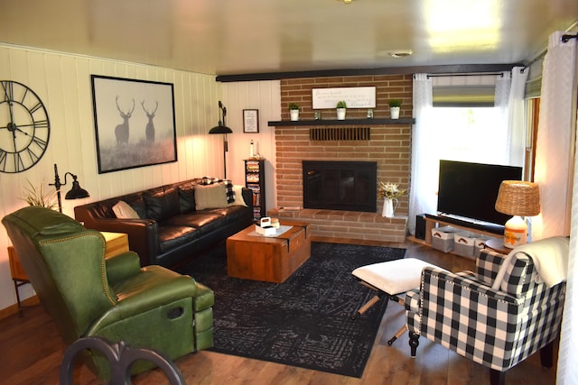 living room featuring a fireplace and wood finished floors