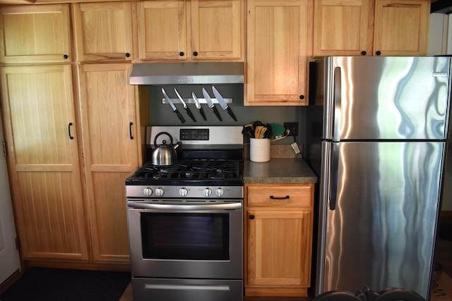 kitchen with stainless steel appliances, dark countertops, and extractor fan