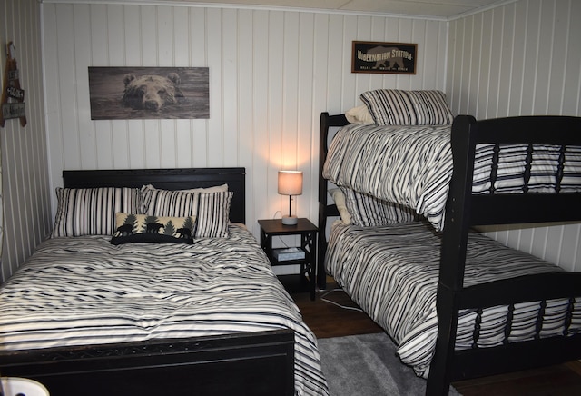 bedroom with ornamental molding and dark wood-style floors