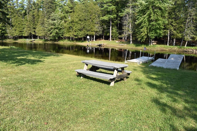 dock area featuring a water view and a yard