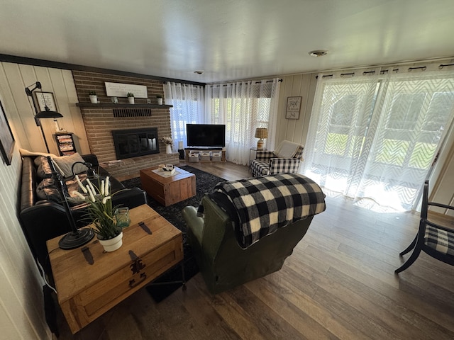 living area featuring wood finished floors and a fireplace