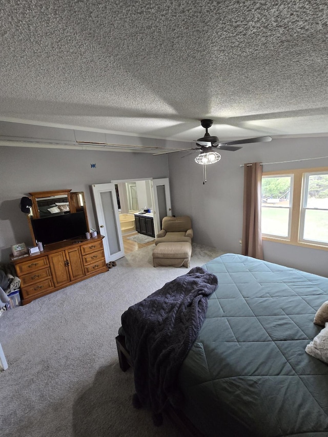 carpeted bedroom featuring a textured ceiling and a ceiling fan