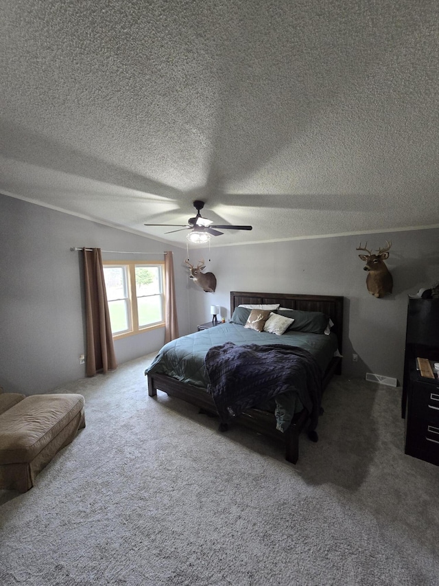 carpeted bedroom featuring a textured ceiling, a ceiling fan, and vaulted ceiling