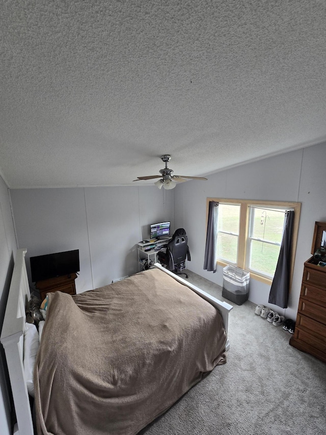 carpeted bedroom with a textured ceiling, ceiling fan, and vaulted ceiling