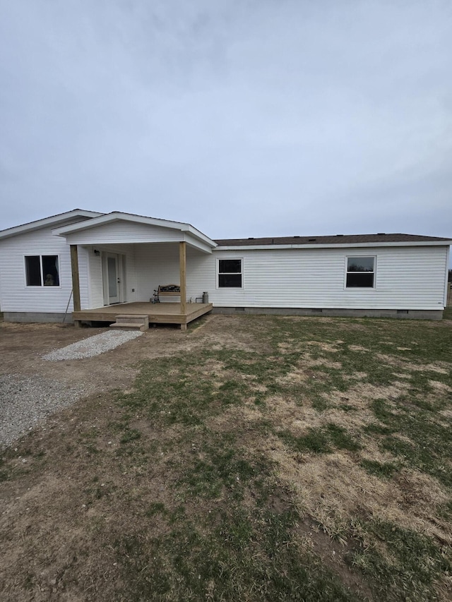 back of property with a deck and crawl space
