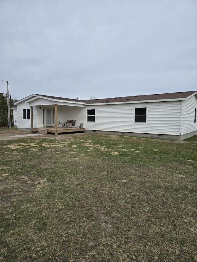 view of front facade with a deck, a front lawn, and crawl space
