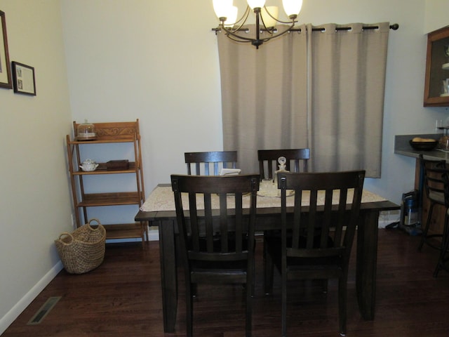dining area featuring an inviting chandelier, baseboards, visible vents, and dark wood-type flooring
