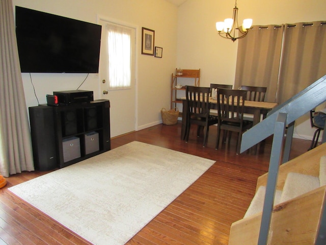 interior space with an inviting chandelier, baseboards, and hardwood / wood-style flooring