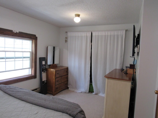 carpeted bedroom with a textured ceiling