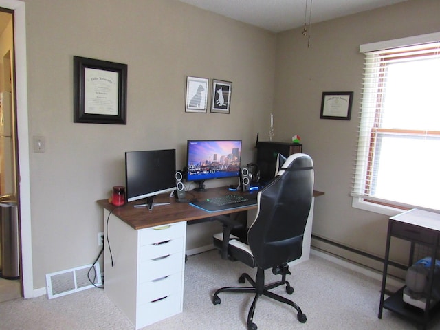 carpeted office space with visible vents, baseboards, and a wealth of natural light