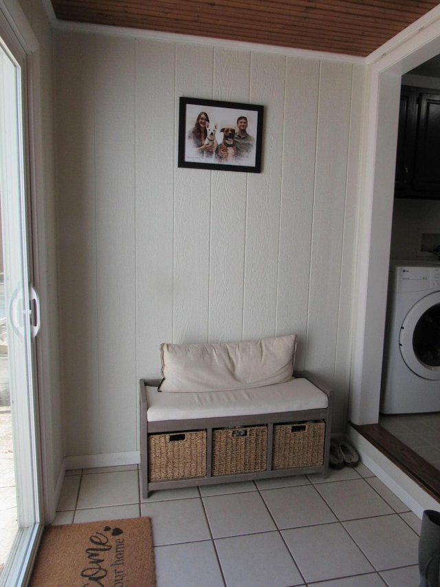 interior space featuring baseboards, washer / clothes dryer, light tile patterned floors, and a healthy amount of sunlight