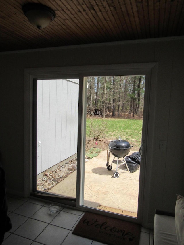 doorway to outside featuring wooden ceiling and tile patterned floors