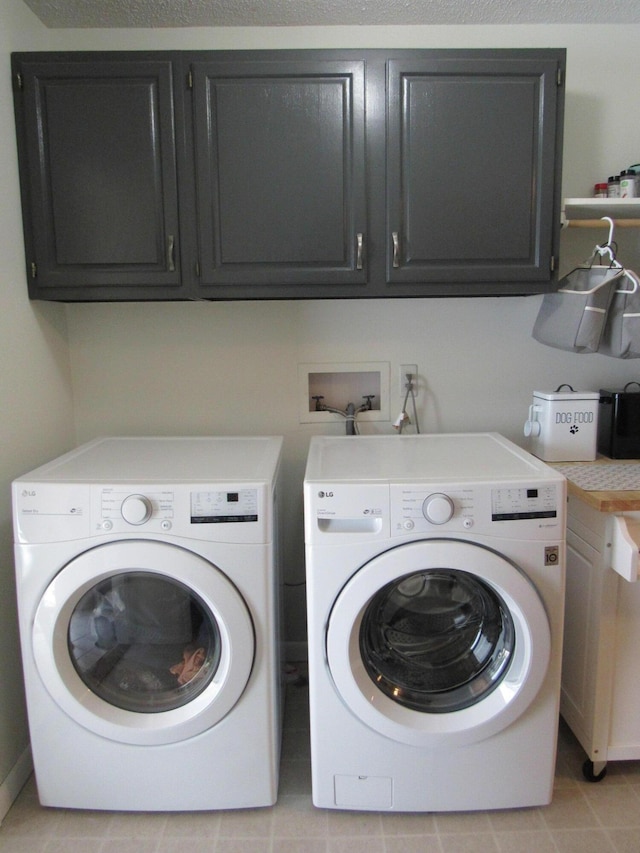 laundry area with cabinet space and washer and clothes dryer