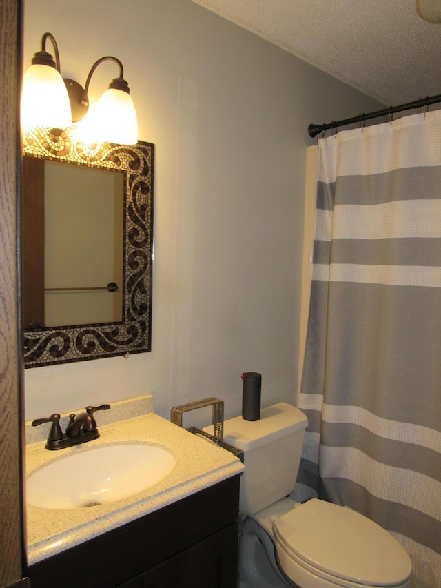 bathroom with toilet, a textured ceiling, a shower with curtain, and vanity