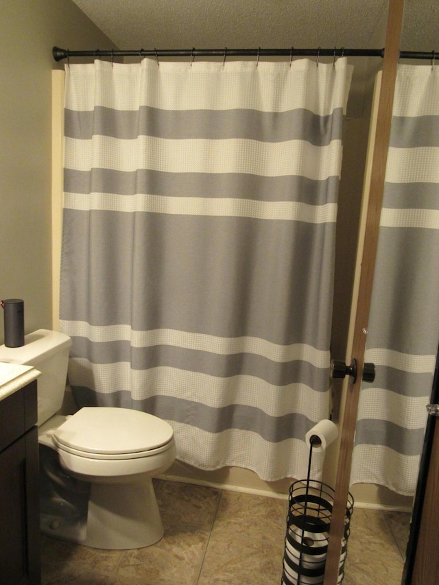 bathroom with vanity, a shower with curtain, toilet, and a textured ceiling