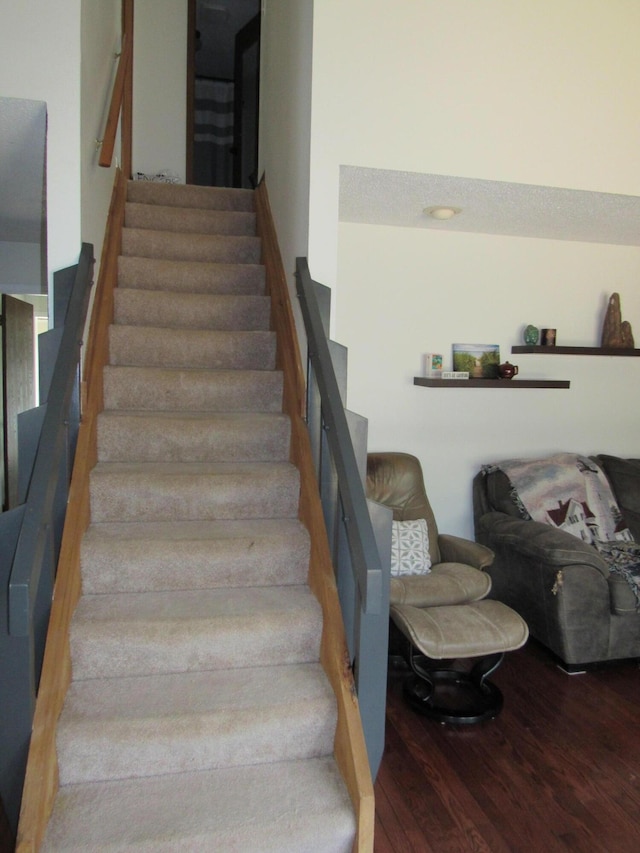 stairway featuring wood finished floors