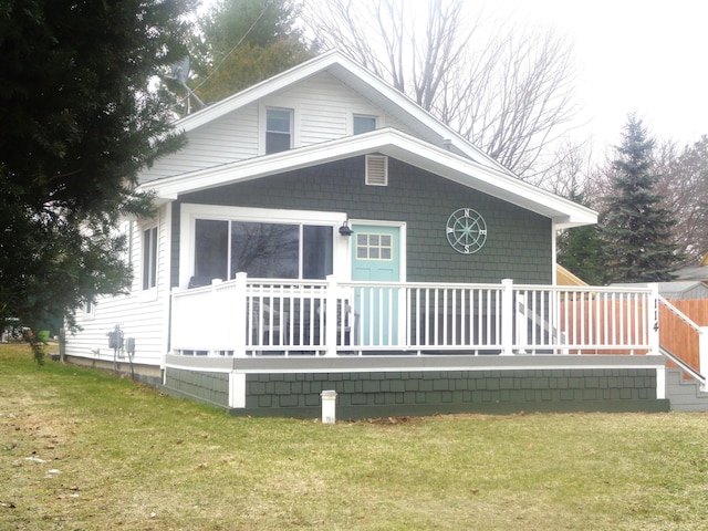 rear view of property with a lawn