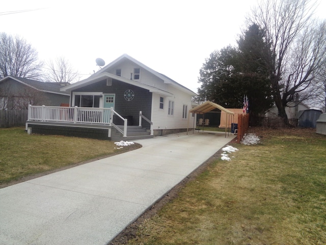 view of front of house featuring a carport, concrete driveway, a front yard, and a deck