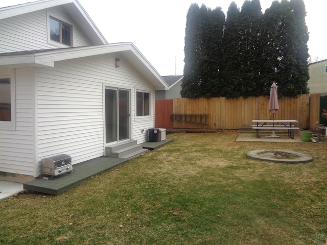 view of yard with fence and entry steps