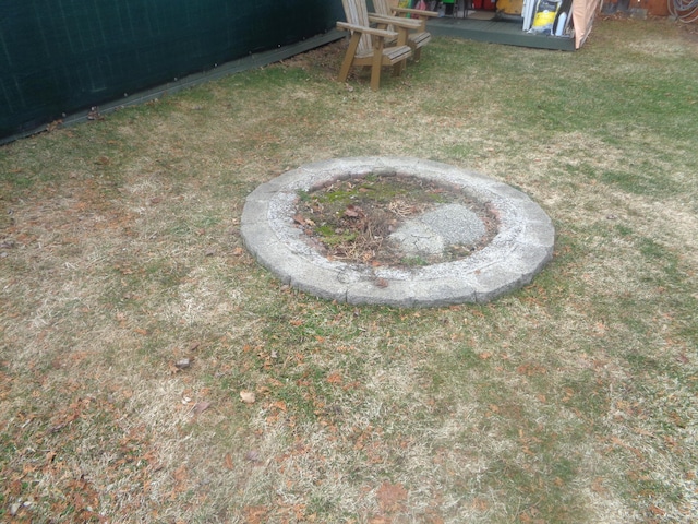 view of yard with a fire pit