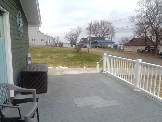 wooden deck featuring a yard, a porch, and a residential view