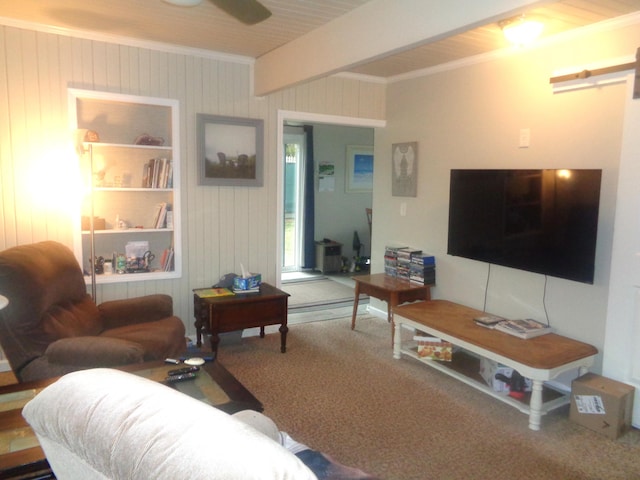 living room featuring beam ceiling, wood walls, crown molding, and carpet flooring