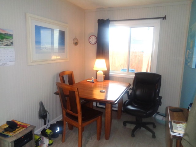 dining space featuring wallpapered walls