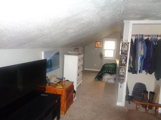bonus room with a textured ceiling, light colored carpet, vaulted ceiling, and baseboards