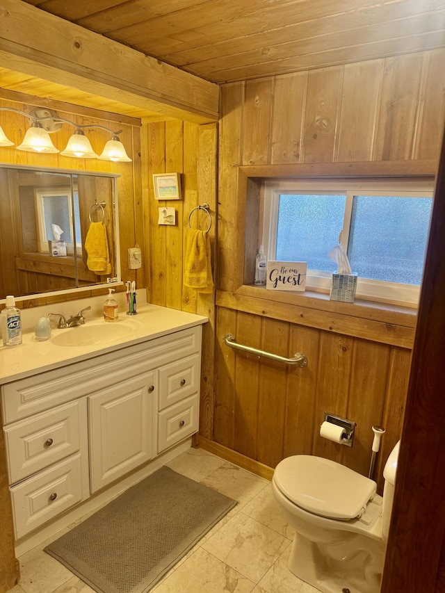 bathroom featuring wood ceiling, wood walls, vanity, toilet, and marble finish floor