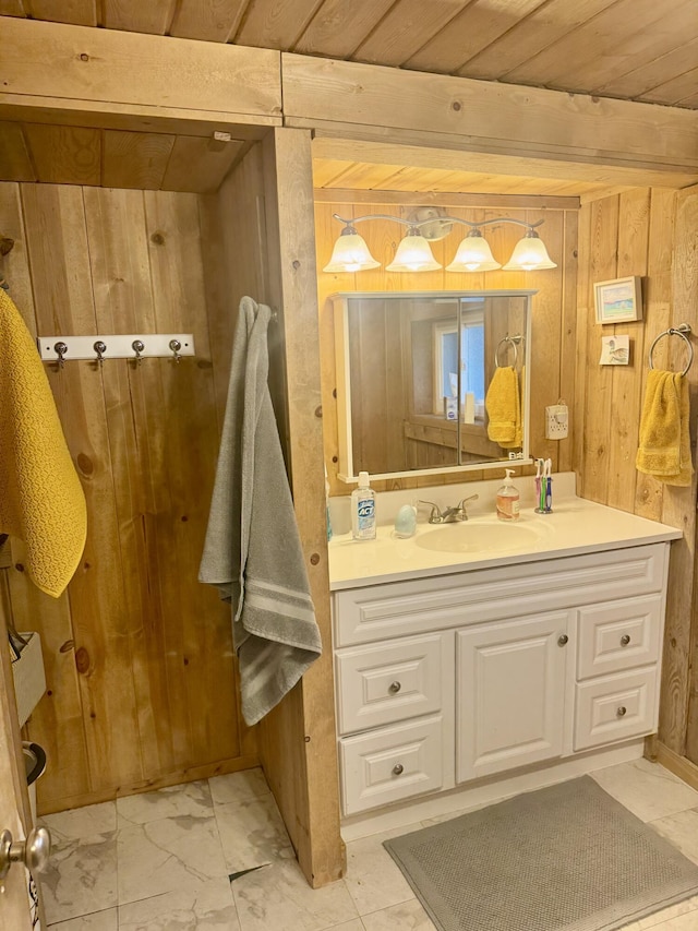 bathroom with vanity, marble finish floor, wooden walls, and wooden ceiling