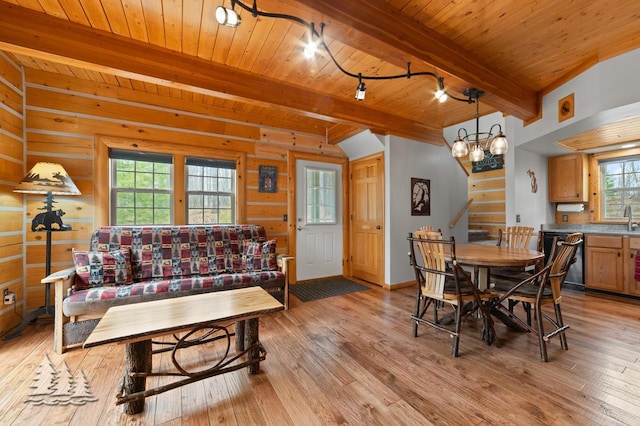 dining space featuring track lighting, wood ceiling, light wood-type flooring, and beam ceiling